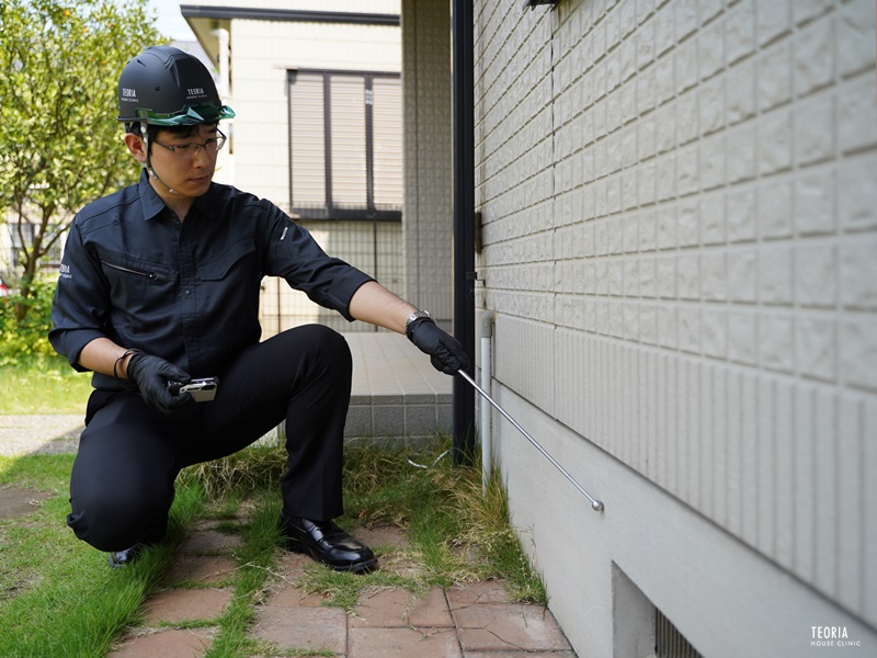 基礎を点検する住宅診断士の様子